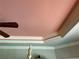 Close-up view of the bedroom's tray ceiling with decorative molding and a ceiling fan at 187 Slate Dr, Buford, GA 30518