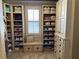 Walk-in closet with custom shelving, drawers, and a window seat for storage and organization at 187 Slate Dr, Buford, GA 30518