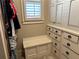 Custom closet featuring a window, built-in bench, and drawers, creating a comfortable and organized space at 187 Slate Dr, Buford, GA 30518