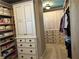 Custom walk-in closet with extensive storage, carpet flooring, and recessed lighting at 187 Slate Dr, Buford, GA 30518
