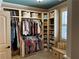 Custom walk-in closet with shelving, drawers, clothes racks and a window bench with natural light at 187 Slate Dr, Buford, GA 30518