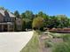 Traditional brick home with a long driveway, mature trees, and meticulously maintained landscaping at 187 Slate Dr, Buford, GA 30518