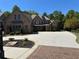 Beautiful brick home with an expansive driveway and well-maintained landscaping at 187 Slate Dr, Buford, GA 30518