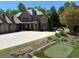 Stunning brick home with a three-car garage, putting green, and meticulously landscaped front yard at 187 Slate Dr, Buford, GA 30518