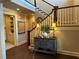 Elegant foyer area with staircase and tastefully decorated console table with lamps at 187 Slate Dr, Buford, GA 30518