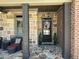 Inviting front porch with stone accents, seating, and a decorated front door at 187 Slate Dr, Buford, GA 30518
