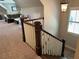 View of the staircase and living room with plush carpet, lots of natural light, and comfortable seating at 187 Slate Dr, Buford, GA 30518