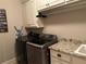 Cozy laundry room featuring modern washer and dryer, granite countertop and convenient cabinet storage at 187 Slate Dr, Buford, GA 30518