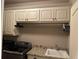 Laundry room features granite counters and ample upper cabinets at 187 Slate Dr, Buford, GA 30518
