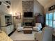 Inviting living room with a stone fireplace, built-in shelving, and comfortable seating for relaxation and gatherings at 187 Slate Dr, Buford, GA 30518