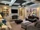 Comfortable living room features a coffered ceiling, custom built-ins, and a cozy fireplace at 187 Slate Dr, Buford, GA 30518