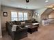 Comfortable living room with a large sectional, a coffee table, and bright natural light at 187 Slate Dr, Buford, GA 30518