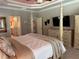 A luxurious bedroom featuring a four-poster bed, ensuite bathroom, and stylish furnishings at 187 Slate Dr, Buford, GA 30518