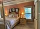 Elegant main bedroom with a four-poster bed, tray ceiling, and neutral decor at 187 Slate Dr, Buford, GA 30518