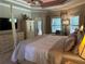 Spacious main bedroom featuring a four-poster bed, sitting area, and ample natural light at 187 Slate Dr, Buford, GA 30518