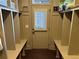 Mudroom features built-in cubbies, bench, and convenient access to the exterior at 187 Slate Dr, Buford, GA 30518