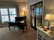Home office with large window and dark wood desk and french doors to the upper porch at 187 Slate Dr, Buford, GA 30518