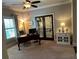 Office features a desk, windows, and access to the upper porch through french doors at 187 Slate Dr, Buford, GA 30518