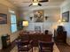 Well-lit office with wood-paneled walls, ceiling fan, large desk and classic decor at 187 Slate Dr, Buford, GA 30518