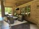 Covered patio with comfortable seating, ceiling fan, and outdoor TV at 187 Slate Dr, Buford, GA 30518