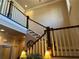 An elegant staircase featuring dark wood rails and white balusters, leading upstairs at 187 Slate Dr, Buford, GA 30518