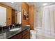 Bathroom featuring granite countertops, stainless steel faucet, and shower over tub with tile surround at 195 14Th St # 1403, Atlanta, GA 30309