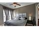 The main bedroom features a ceiling fan, a large window and gray walls at 195 14Th St # 1403, Atlanta, GA 30309