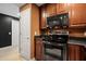 Modern kitchen with wood cabinets, stainless steel appliances, and a dark countertop at 195 14Th St # 1403, Atlanta, GA 30309