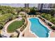 Aerial view showcasing a refreshing swimming pool and landscaped grounds for outdoor enjoyment at 195 14Th St # 1403, Atlanta, GA 30309