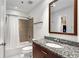 Bright bathroom boasts granite vanity, shower-tub with white curtain, and large mirror at 250 Pharr Ne Rd # 1113, Atlanta, GA 30305