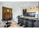 Modern kitchen with black countertops and cabinets, gold accents and eat-in breakfast bar at 250 Pharr Ne Rd # 1113, Atlanta, GA 30305