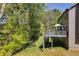 View of a backyard featuring a two-level deck nestled among mature trees, offering a peaceful outdoor space at 4095 Fastnet Ln, Duluth, GA 30096