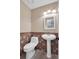 Half bathroom with pedestal sink and tile wainscoting at 4095 Fastnet Ln, Duluth, GA 30096