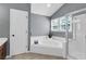 Bright bathroom featuring a tub, shower, and a window bringing in natural light at 4095 Fastnet Ln, Duluth, GA 30096