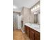 Spacious bathroom featuring a double vanity, a mirror, and a tub with a shower at 4095 Fastnet Ln, Duluth, GA 30096