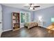 Cozy bedroom with hardwood floors, a window, a colorful bed, and a ceiling fan at 4095 Fastnet Ln, Duluth, GA 30096