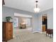 Open-concept dining area with neutral tones and a view into the living room and kitchen areas at 4095 Fastnet Ln, Duluth, GA 30096