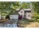 Charming two-story home with a well-manicured lawn, lush landscaping and a two-car garage at 4095 Fastnet Ln, Duluth, GA 30096