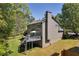 Back exterior view of the house, highlighted by green grass and a large back deck at 4095 Fastnet Ln, Duluth, GA 30096