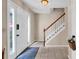 Inviting foyer features tile flooring, a staircase with white railings, and a bright front door at 4095 Fastnet Ln, Duluth, GA 30096