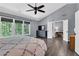 Main bedroom with ensuite bathroom, TV and large windows at 4095 Fastnet Ln, Duluth, GA 30096