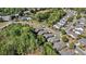 An aerial view of the community with lush greenery, well-maintained roads, and a glimpse of the neighborhood pool at 4930 Kings Common Way, Cumming, GA 30040