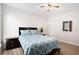 Bedroom with natural light, complemented by wood-look flooring and neutral wall paint at 4930 Kings Common Way, Cumming, GA 30040
