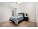 Cozy bedroom featuring a queen-sized bed with a blue patterned comforter and a wooden nightstand at 4930 Kings Common Way, Cumming, GA 30040