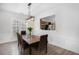Cozy dining room with modern chandelier and a view to the kitchen at 4930 Kings Common Way, Cumming, GA 30040