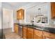 Stylish kitchen with granite counters, stainless steel appliances and a view to the living room at 4930 Kings Common Way, Cumming, GA 30040