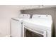 The laundry room features a white, front load washer and dryer at 4930 Kings Common Way, Cumming, GA 30040