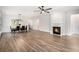 Bright and airy living room with a cozy fireplace and sleek hardwood flooring at 4930 Kings Common Way, Cumming, GA 30040
