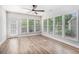 Bright sunroom with large windows, hardwood flooring, and door to the exterior at 4930 Kings Common Way, Cumming, GA 30040