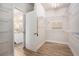 Open walk-in closet with shelving and a view into the bathroom that has a granite vanity top at 4930 Kings Common Way, Cumming, GA 30040